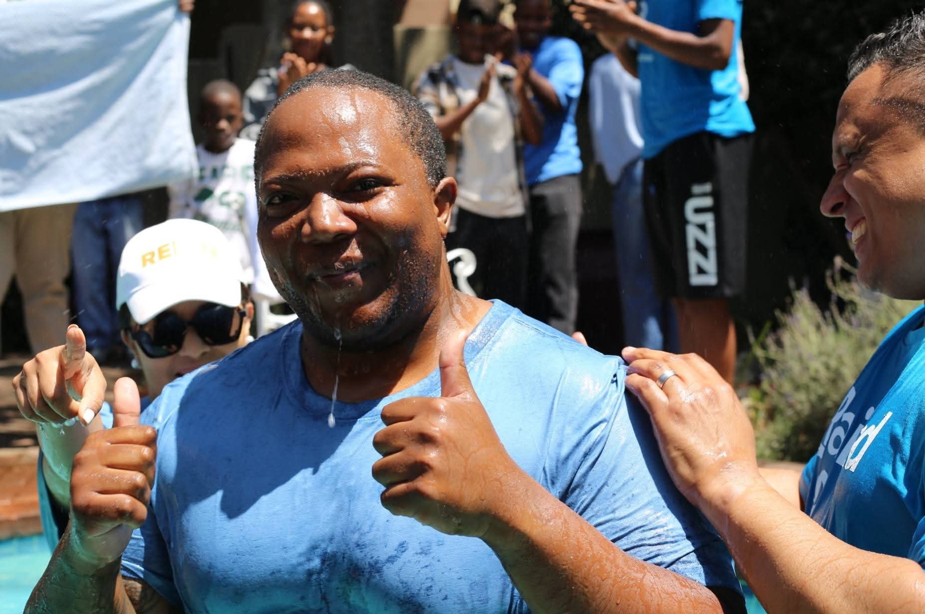 Man giving two thumbs up beside the baptism pool after being baptised at REIGN Church