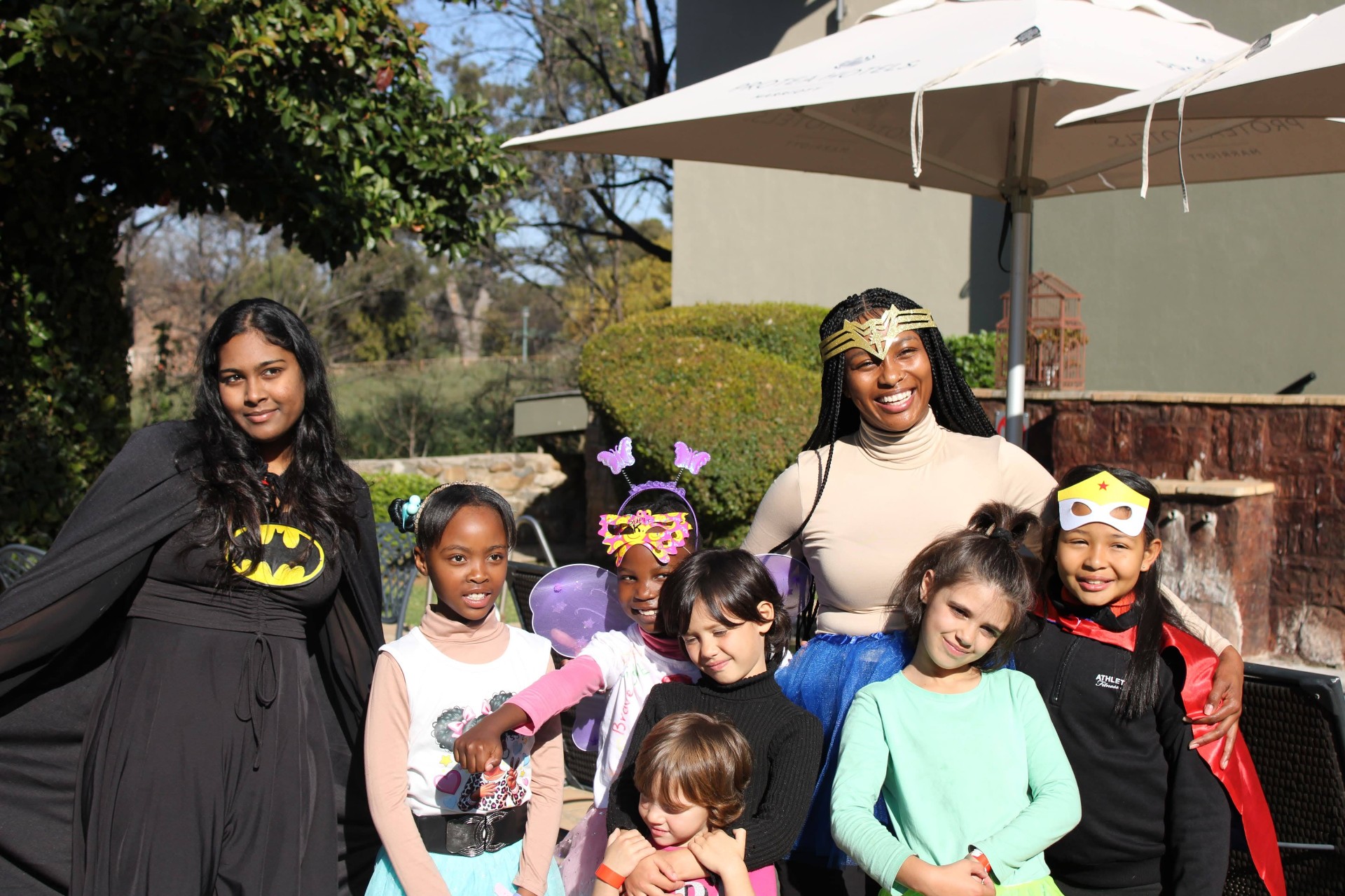REIGN Kids children and leaders with arms around each other at a dress-up Sunday